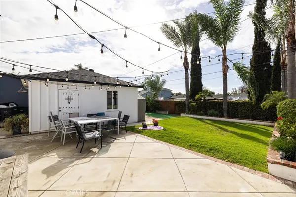 a view of backyard with outdoor seating and plants