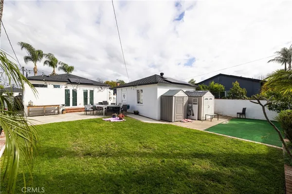 a view of a house with a yard and sitting area