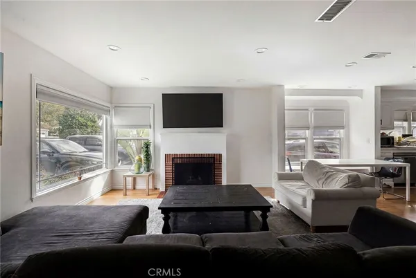 a living room with furniture a large window and a fireplace