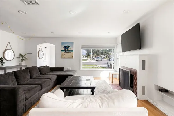a living room with fireplace furniture and a flat screen tv