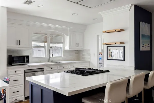 a kitchen with a stove a sink and a refrigerator