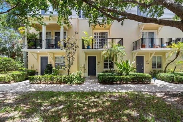 a front view of a residential houses with yard and green space