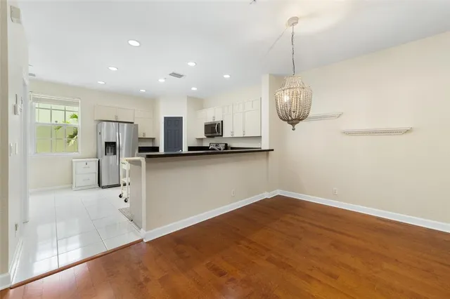 a view of kitchen with refrigerator and window