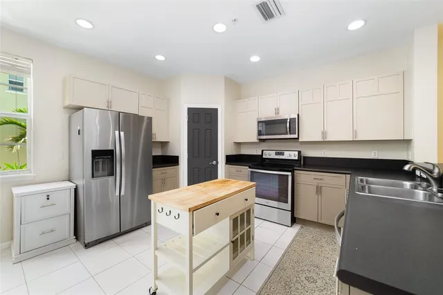 a kitchen with a refrigerator stove and microwave