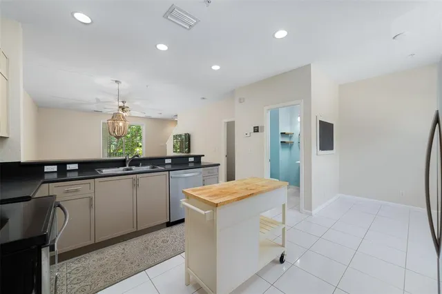 a kitchen with granite countertop cabinets a sink and appliances