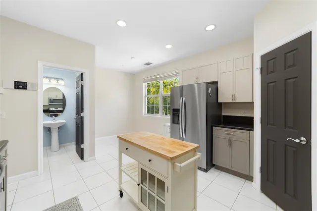 a kitchen with a refrigerator and a sink