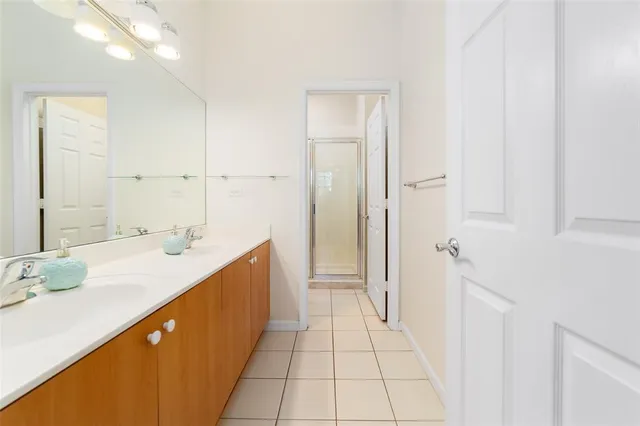 a spacious bathroom with a granite countertop sink and a mirror