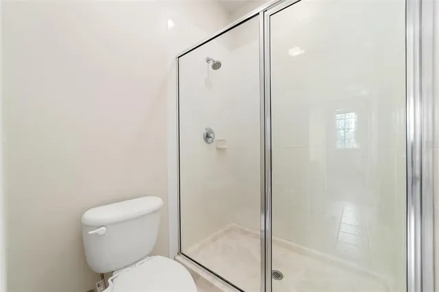 a bathroom with a toilet and a shower