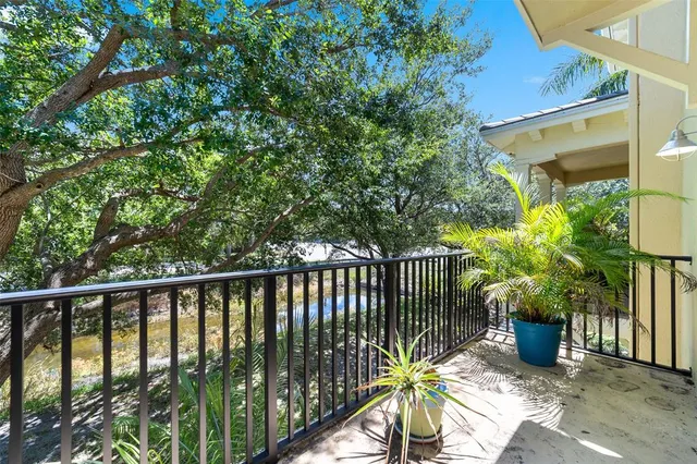 a view of a balcony with potted plants