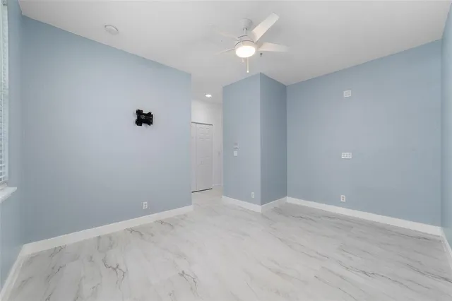 a view of an empty room with a fan