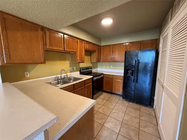 a kitchen with a sink a stove and cabinets