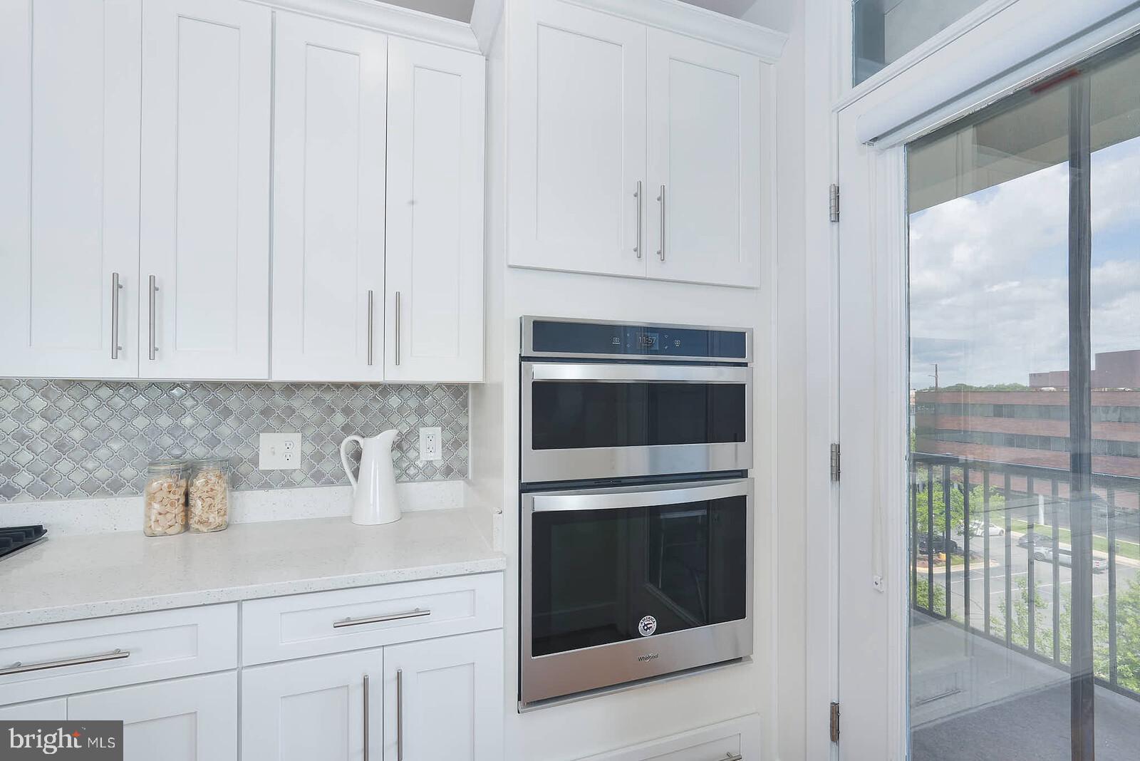 11200 Reston Station Boulevard, Unit 508 Reston, VA 20190 - Photo 8 of 29 Kitchen and door out to small patio