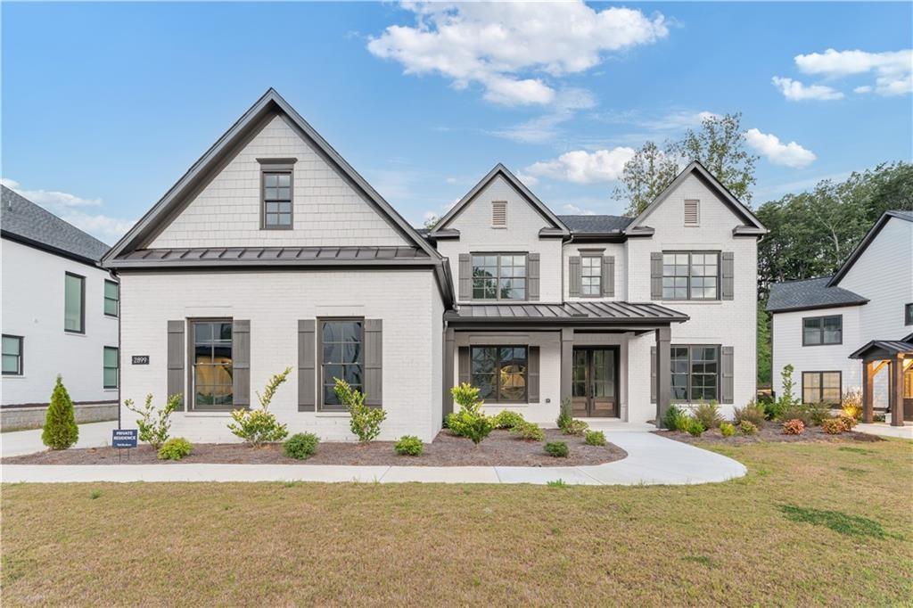 2899 Treeside Terrace Marietta, GA 30066 - Photo 1 of 1 a front view of a house with a garden and patio