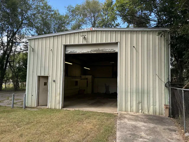 a view of a entrance gate of a house with an outdoor space