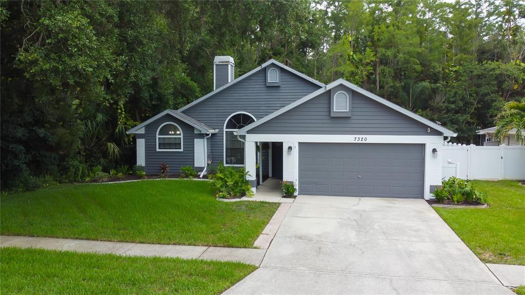 7320 Hideaway Trail New Port Richey, FL 34655 - Photo 1 of 1 a front view of house with yard and green space