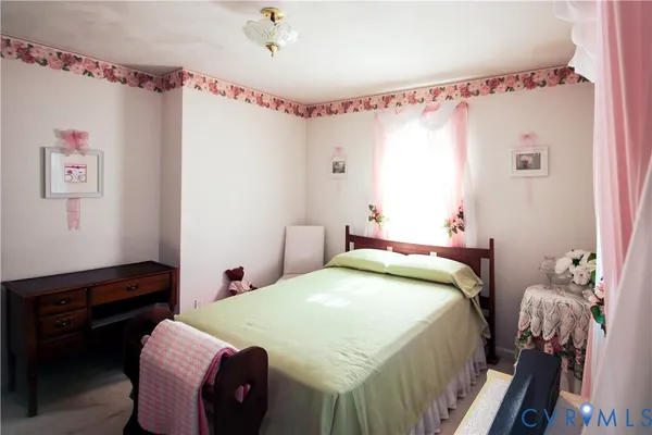 a bedroom with a bed and a dresser in it