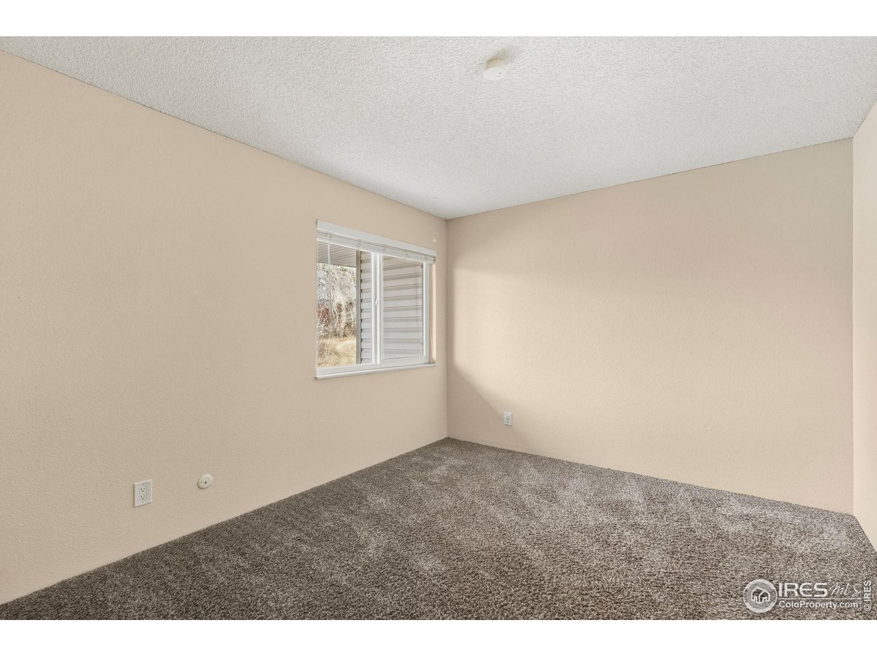 1705 Heatheridge Road, Unit 103 Fort Collins, CO 80526 - Photo 12 of 16 an empty room with windows