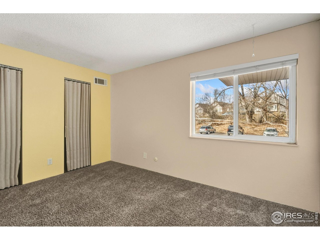 1705 Heatheridge Road, Unit 103 Fort Collins, CO 80526 - Photo 13 of 16 an empty room with painting on the wall