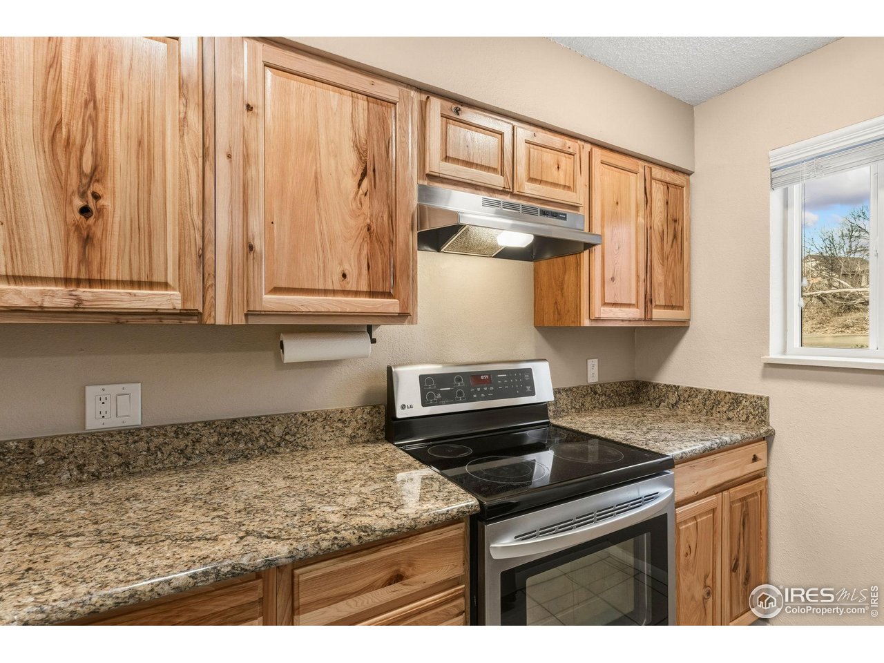 1705 Heatheridge Road, Unit 103 Fort Collins, CO 80526 - Photo 4 of 16 a kitchen with stainless steel appliances granite countertop a sink stove and cabinets
