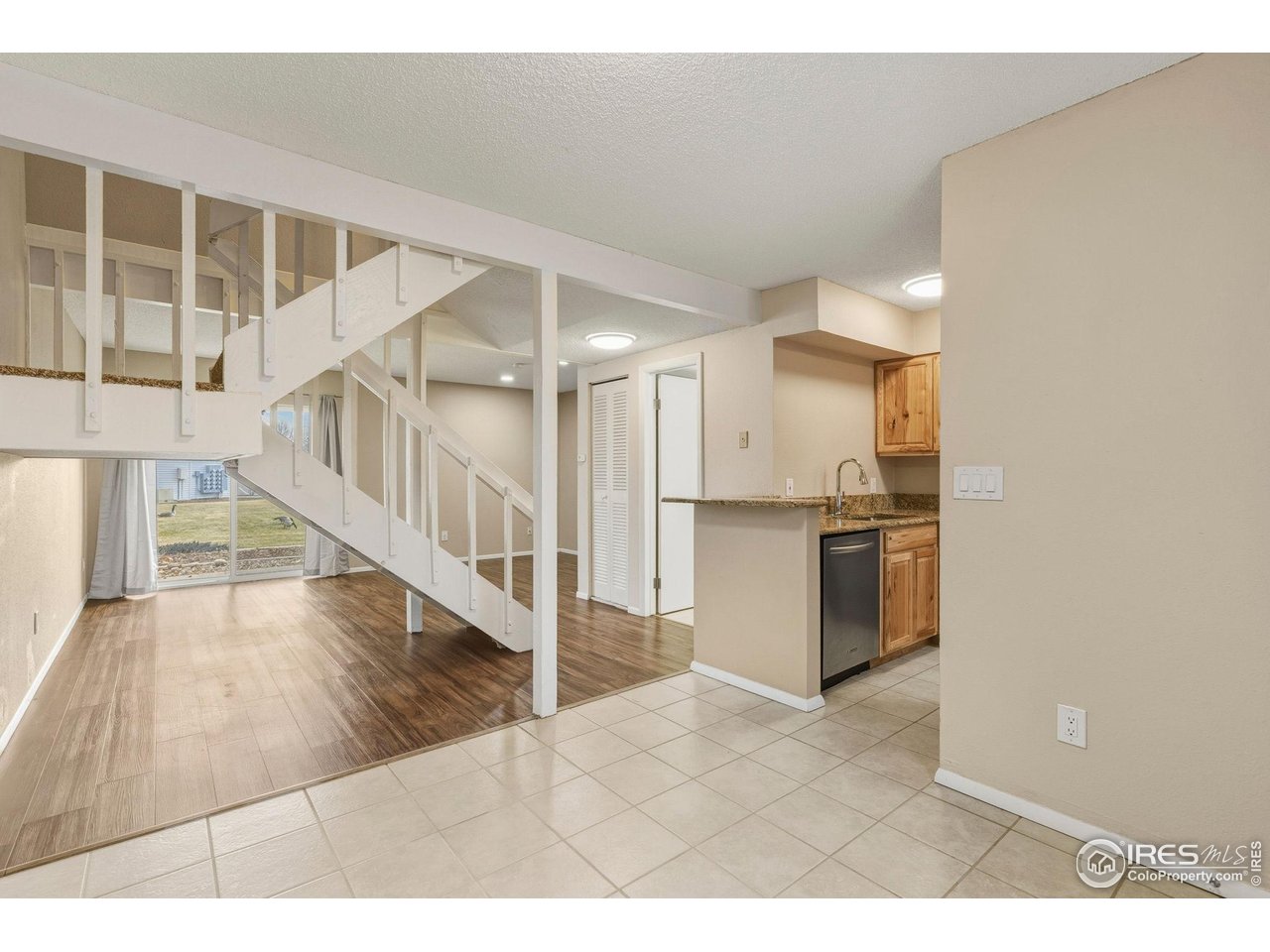 1705 Heatheridge Road, Unit 103 Fort Collins, CO 80526 - Photo 5 of 16 a view interior of a house and kitchen view with wooden floor