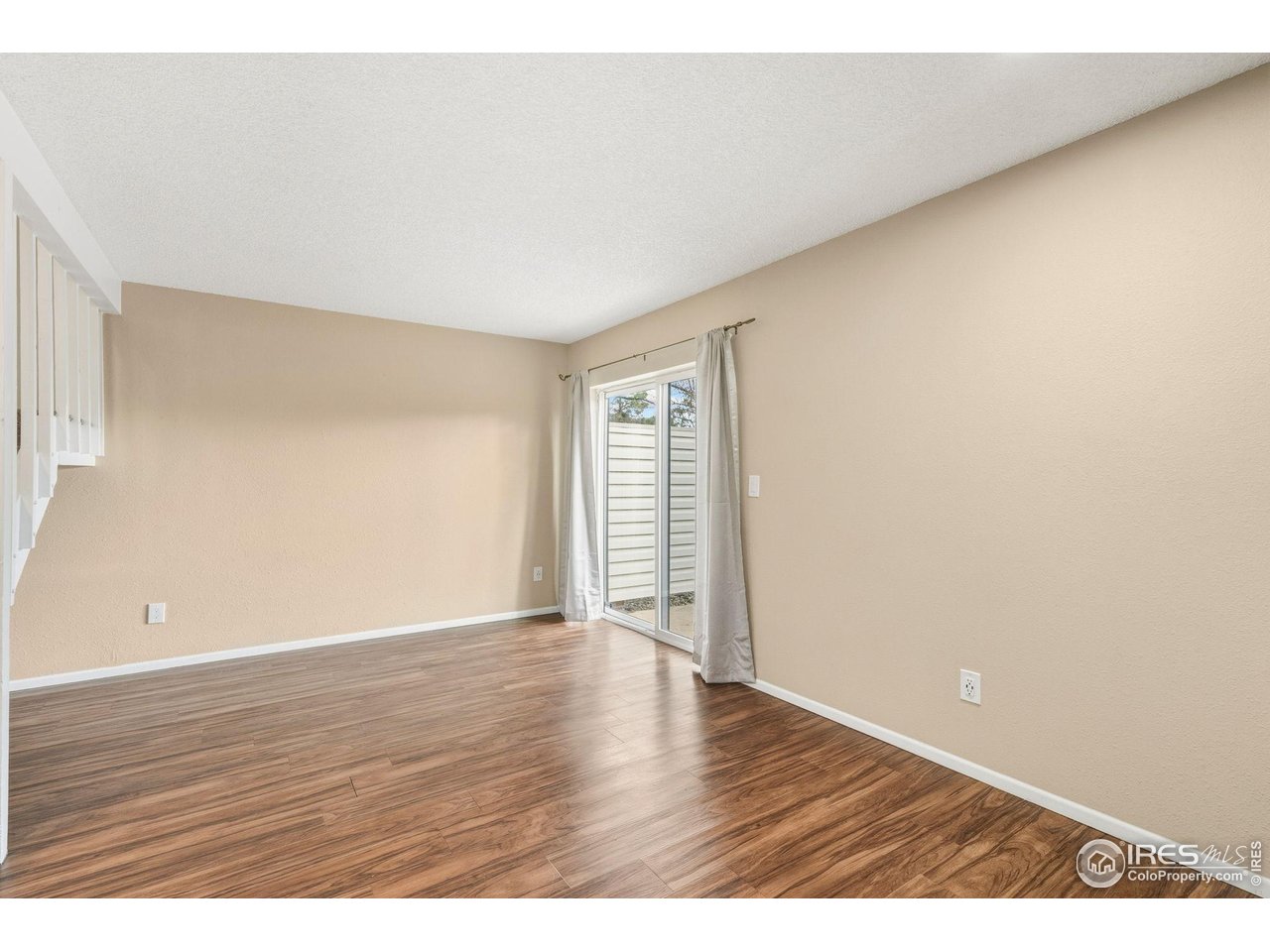 1705 Heatheridge Road, Unit 103 Fort Collins, CO 80526 - Photo 7 of 16 a view of an empty room with wooden floor