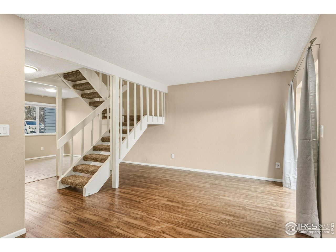 1705 Heatheridge Road, Unit 103 Fort Collins, CO 80526 - Photo 8 of 16 a view of entryway and hall with wooden floor
