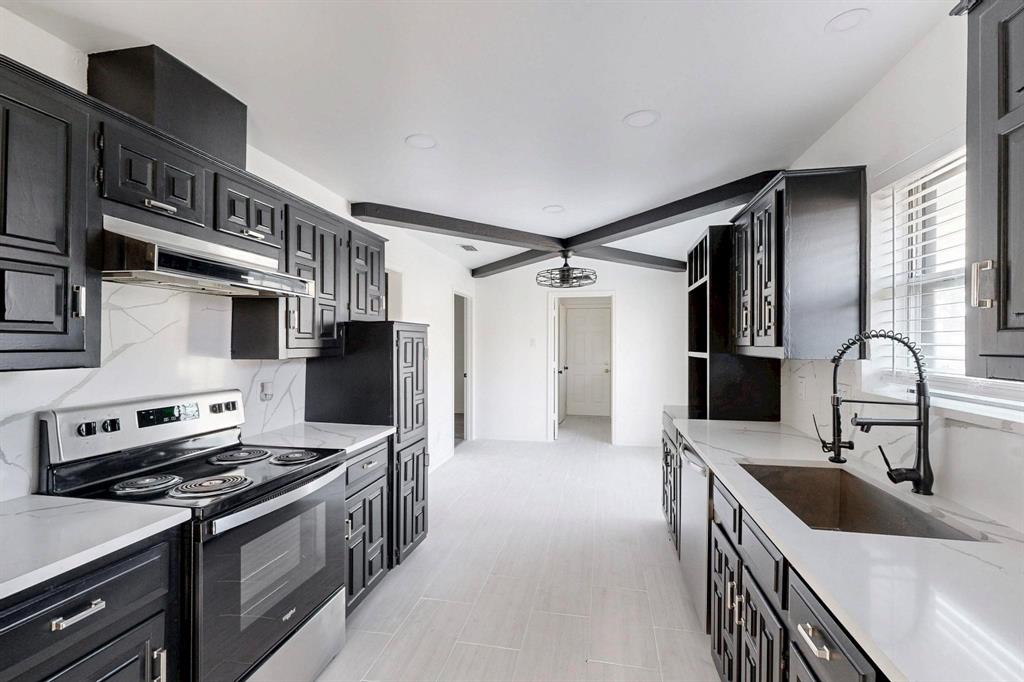 6529 Braddock Place Dallas, TX 75232 - Photo 1 of 1 Kitchen with ventilation hood, backsplash, a sink, electric stove, and dark cabinets