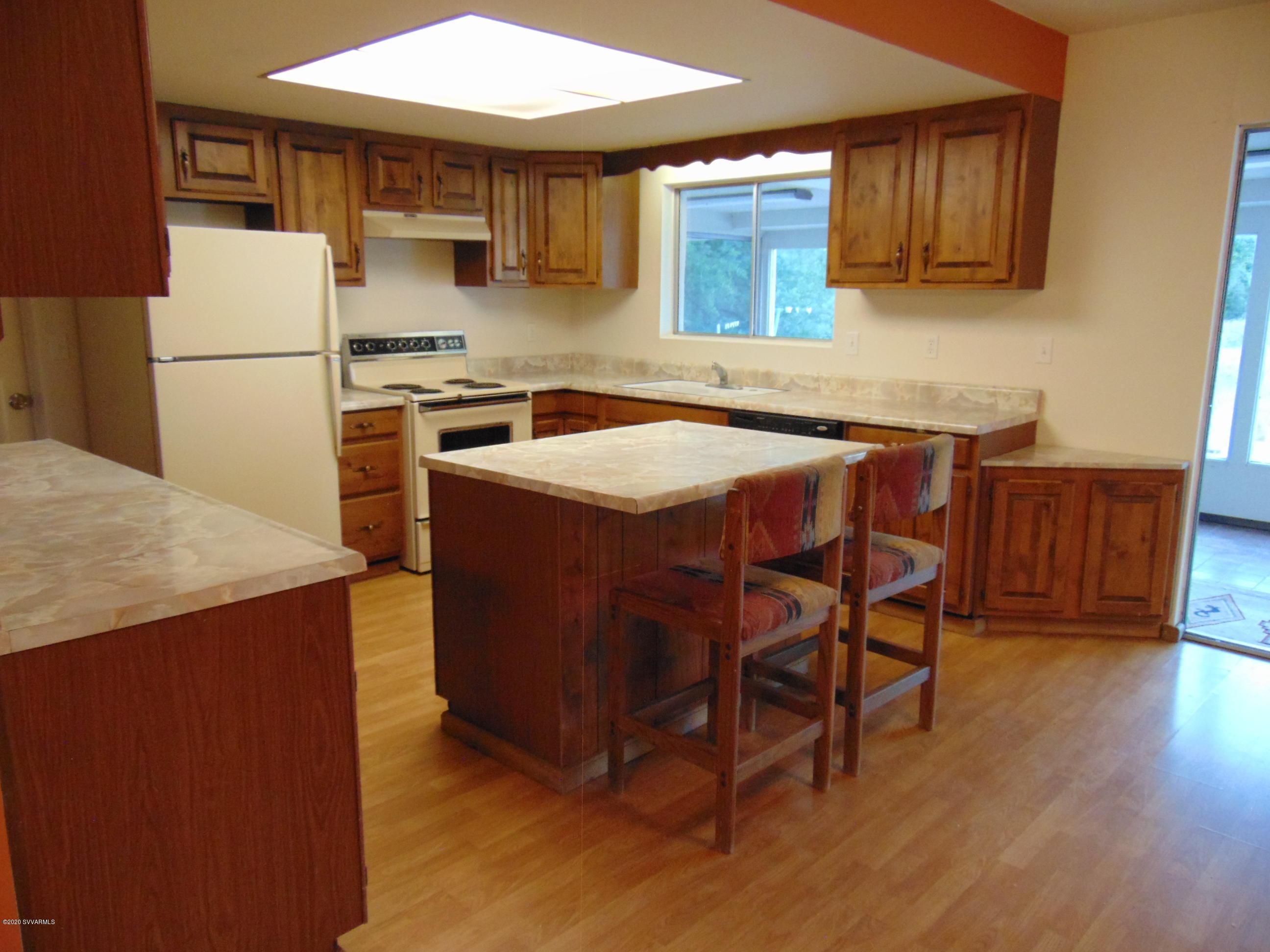 3548 East Rimrock Drive Rimrock, AZ 86335 - Photo 6 of 30 a kitchen with a wooden table and chairs