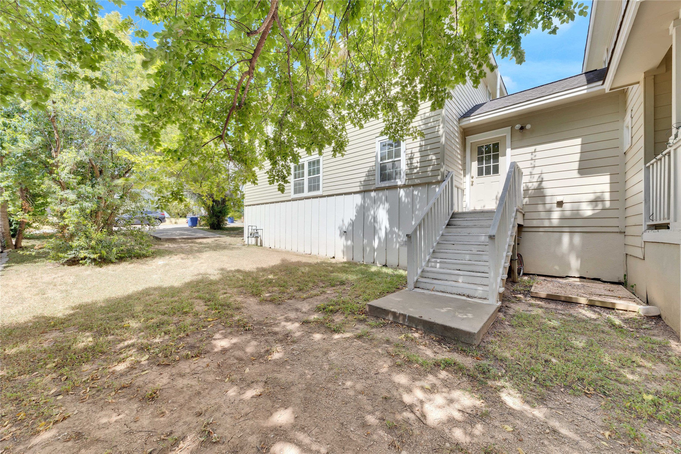 2201 East 18th Street, Unit B Austin, TX 78702 - Photo 20 of 25 A side entrance with wooden steps leads to this well-maintained residence.