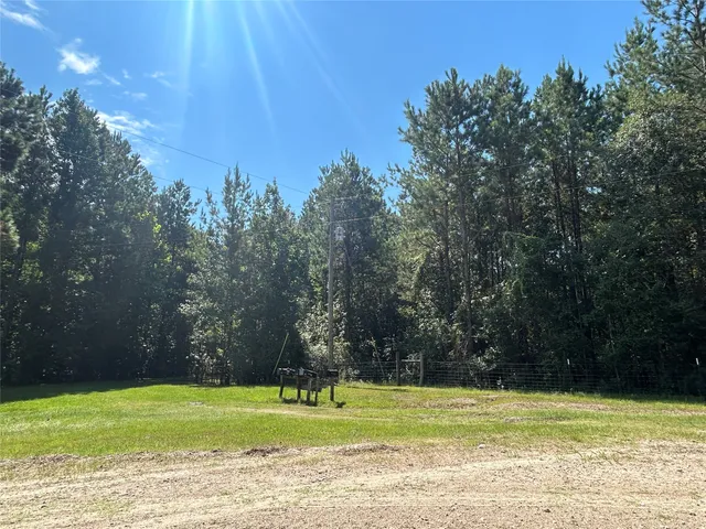 a view of a swimming pool and a yard