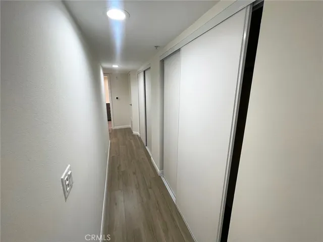 a view of a hallway with wooden floor