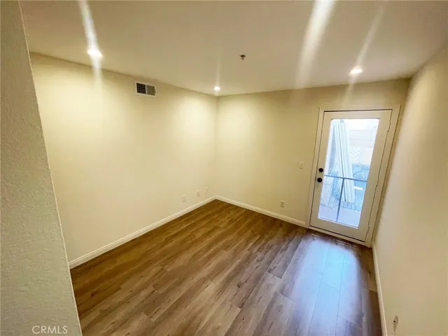 a view of a room with wooden floor and brick wall