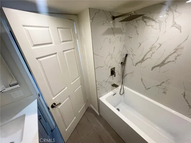 a bathroom with a bathtub and shower