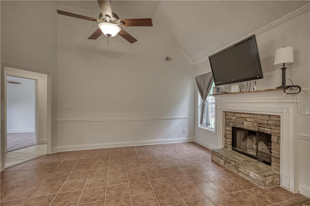 115 Huntington Street Covington, GA 30016 - Photo 12 of 77 a living room with a fireplace and a flat screen tv