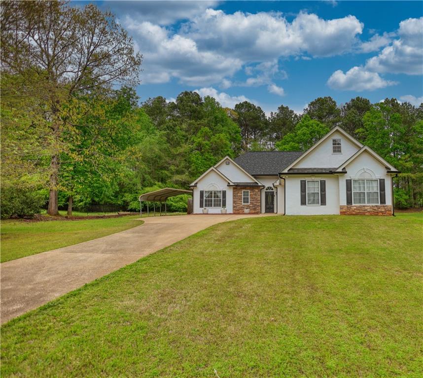 115 Huntington Street Covington, GA 30016 - Photo 2 of 77 a front of a house with a garden