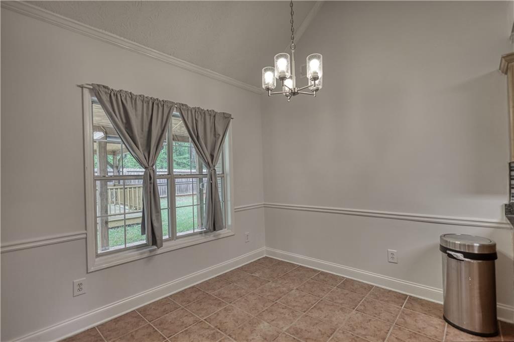 115 Huntington Street Covington, GA 30016 - Photo 21 of 77 a view of empty room with windows