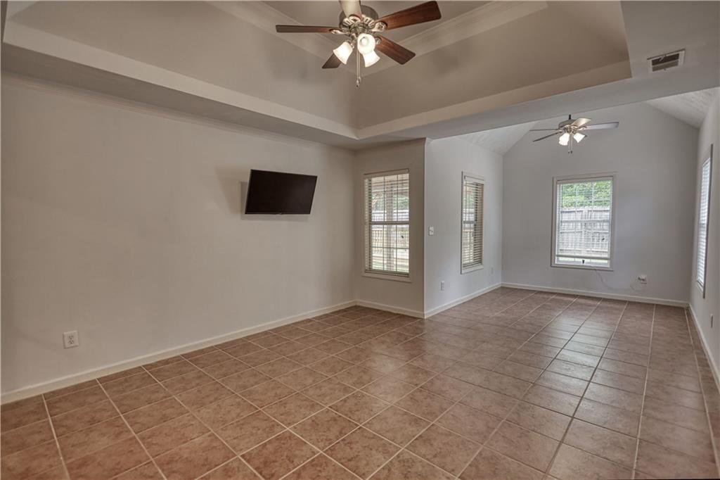 115 Huntington Street Covington, GA 30016 - Photo 28 of 77 an empty room with chandelier fan and windows