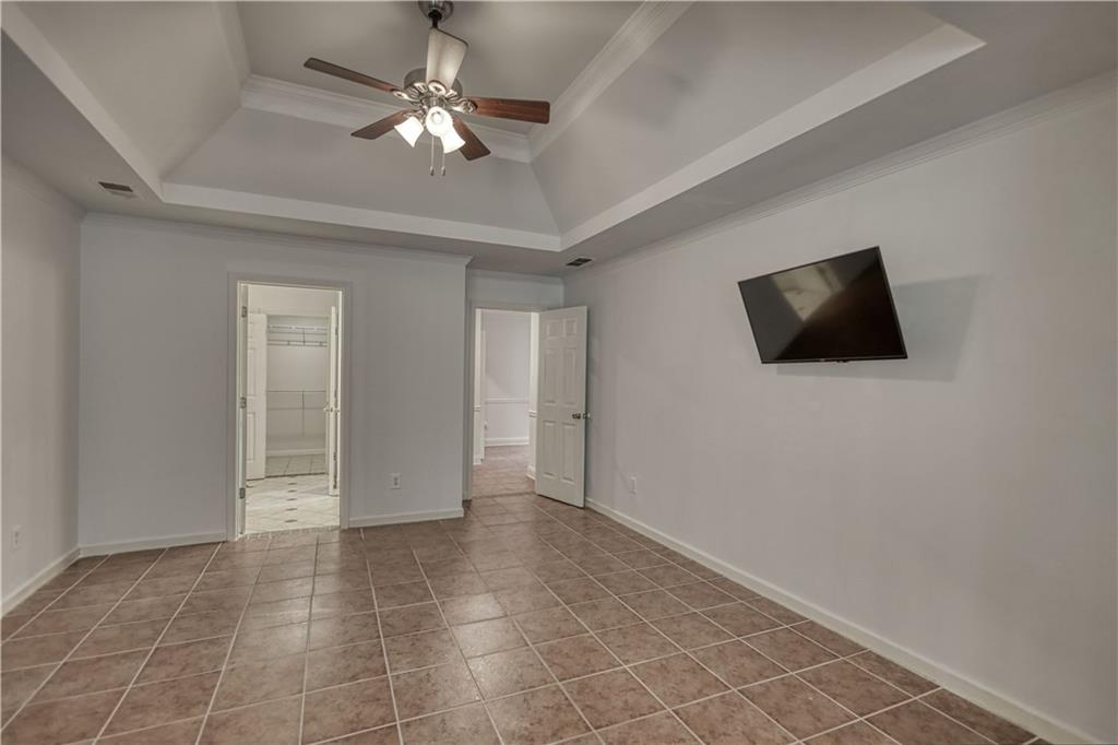 115 Huntington Street Covington, GA 30016 - Photo 30 of 77 a view of an empty room with a ceiling fan and a window