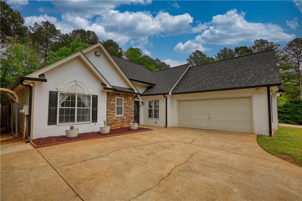 115 Huntington Street Covington, GA 30016 - Photo 3 of 77 a view of a house with porch and garden