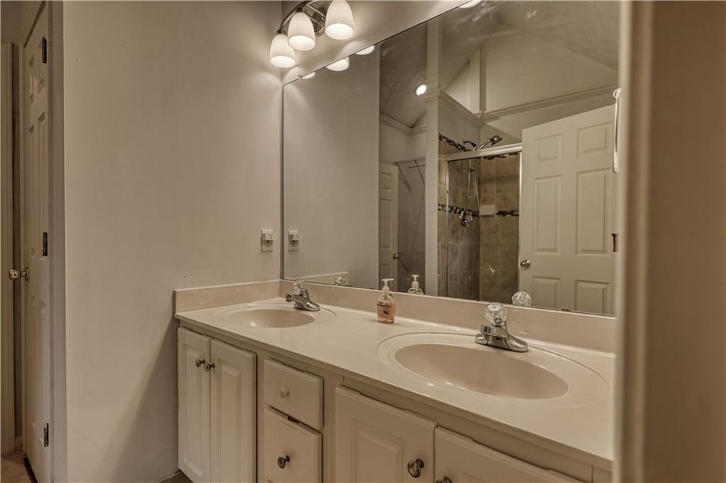115 Huntington Street Covington, GA 30016 - Photo 32 of 77 a bathroom with a sink double vanity and a mirror
