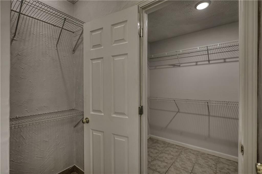115 Huntington Street Covington, GA 30016 - Photo 35 of 77 a bathroom with a glass shower door