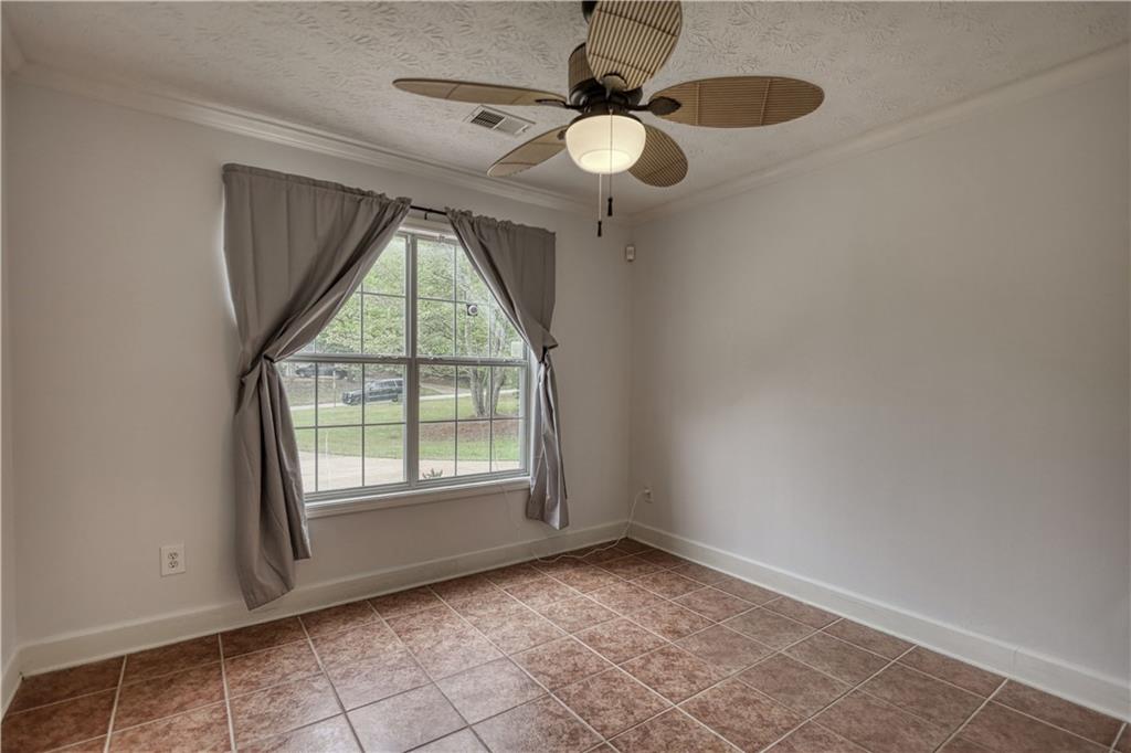 115 Huntington Street Covington, GA 30016 - Photo 37 of 77 an empty room with windows and fan