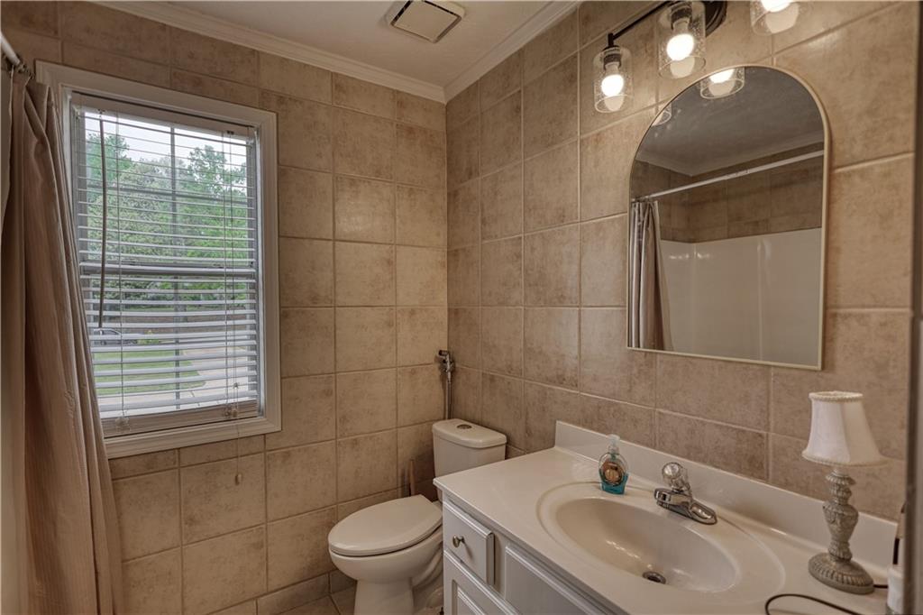 115 Huntington Street Covington, GA 30016 - Photo 41 of 77 a bathroom with a sink toilet and shower