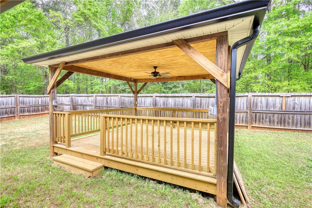 115 Huntington Street Covington, GA 30016 - Photo 56 of 77 a view of backyard with a small deck and wooden fence