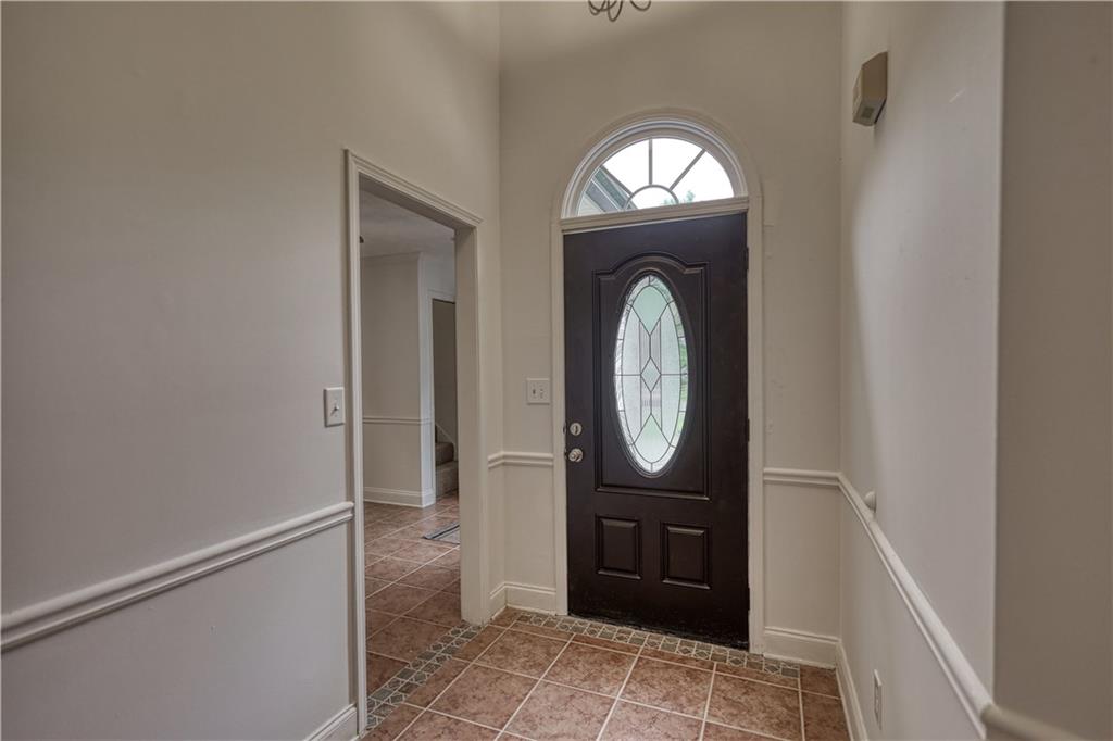 115 Huntington Street Covington, GA 30016 - Photo 6 of 77 a view of a entryway door with wooden floor