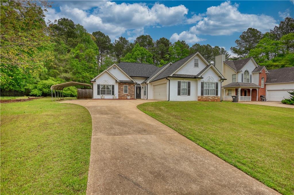 115 Huntington Street Covington, GA 30016 - Photo 65 of 77 a view of a house with a big yard and large trees