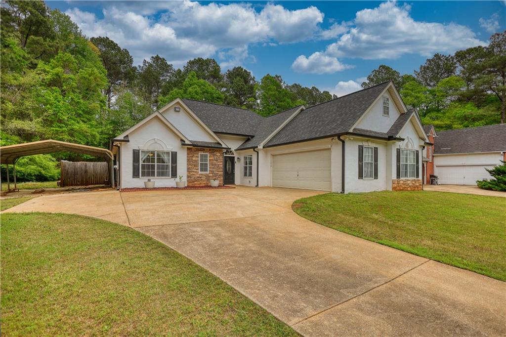115 Huntington Street Covington, GA 30016 - Photo 66 of 77 a front view of a house with a garden