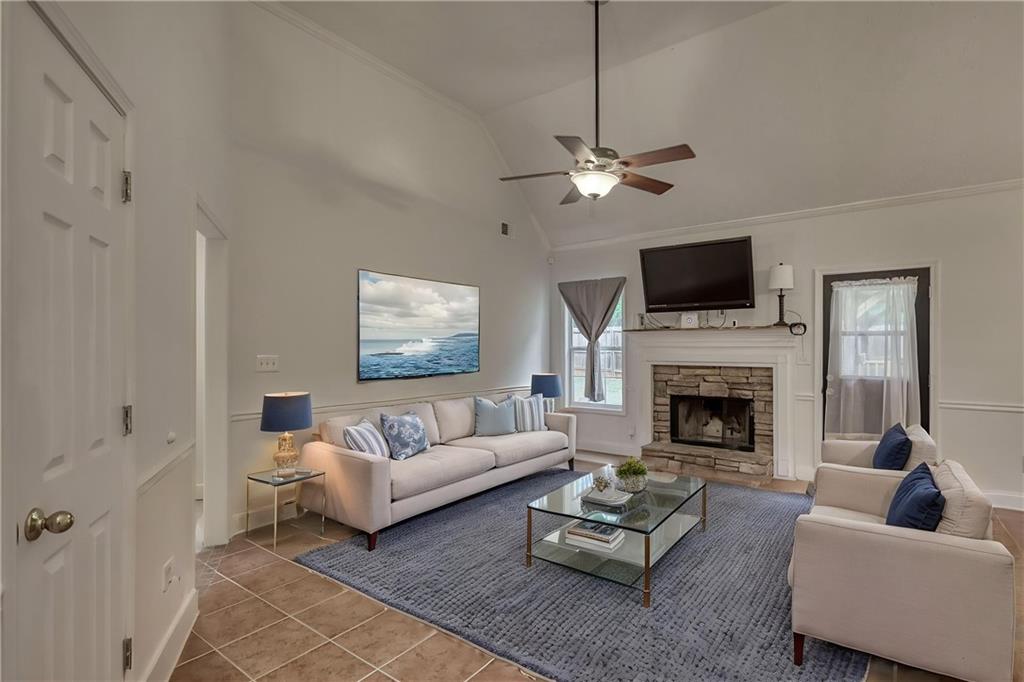 115 Huntington Street Covington, GA 30016 - Photo 7 of 77 a living room with furniture a fireplace and a flat screen tv