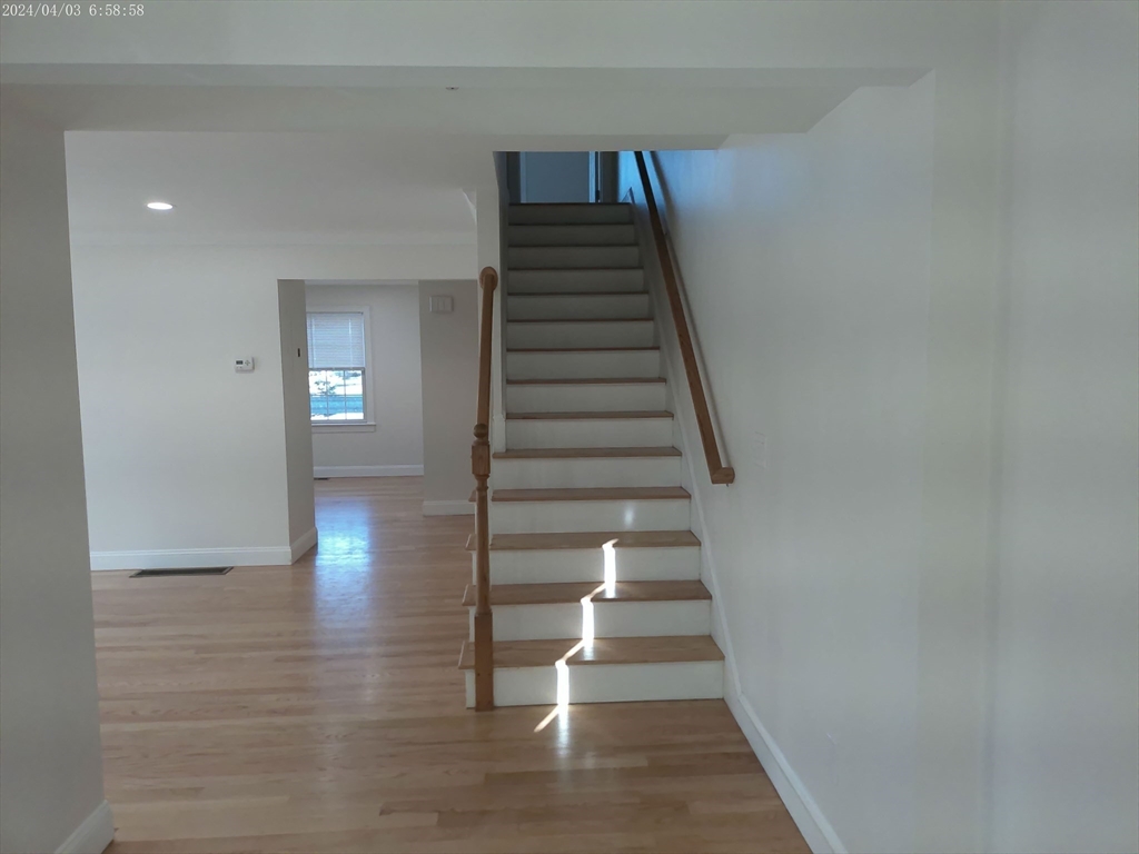 857 Washington Street, Unit 857 Canton, MA 02021 - Photo 9 of 17 a view of entryway and hall with wooden floor