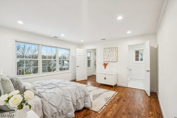 a spacious bedroom with a large bed and a large window